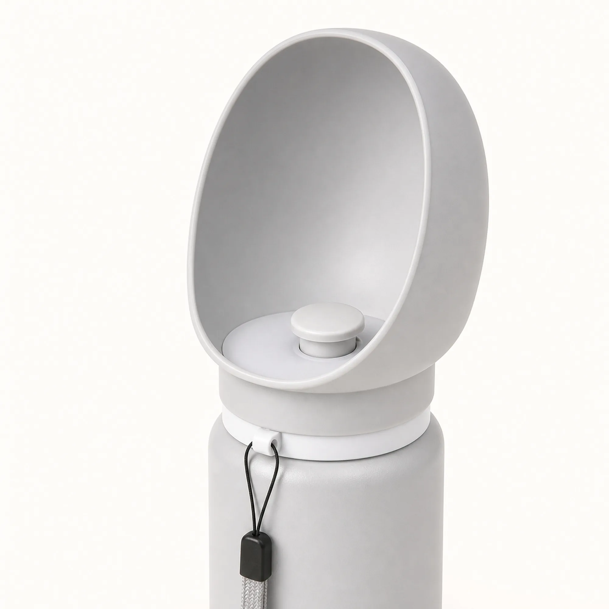 Wide oval drinking bowl with round return-valve control on a light grey bottle