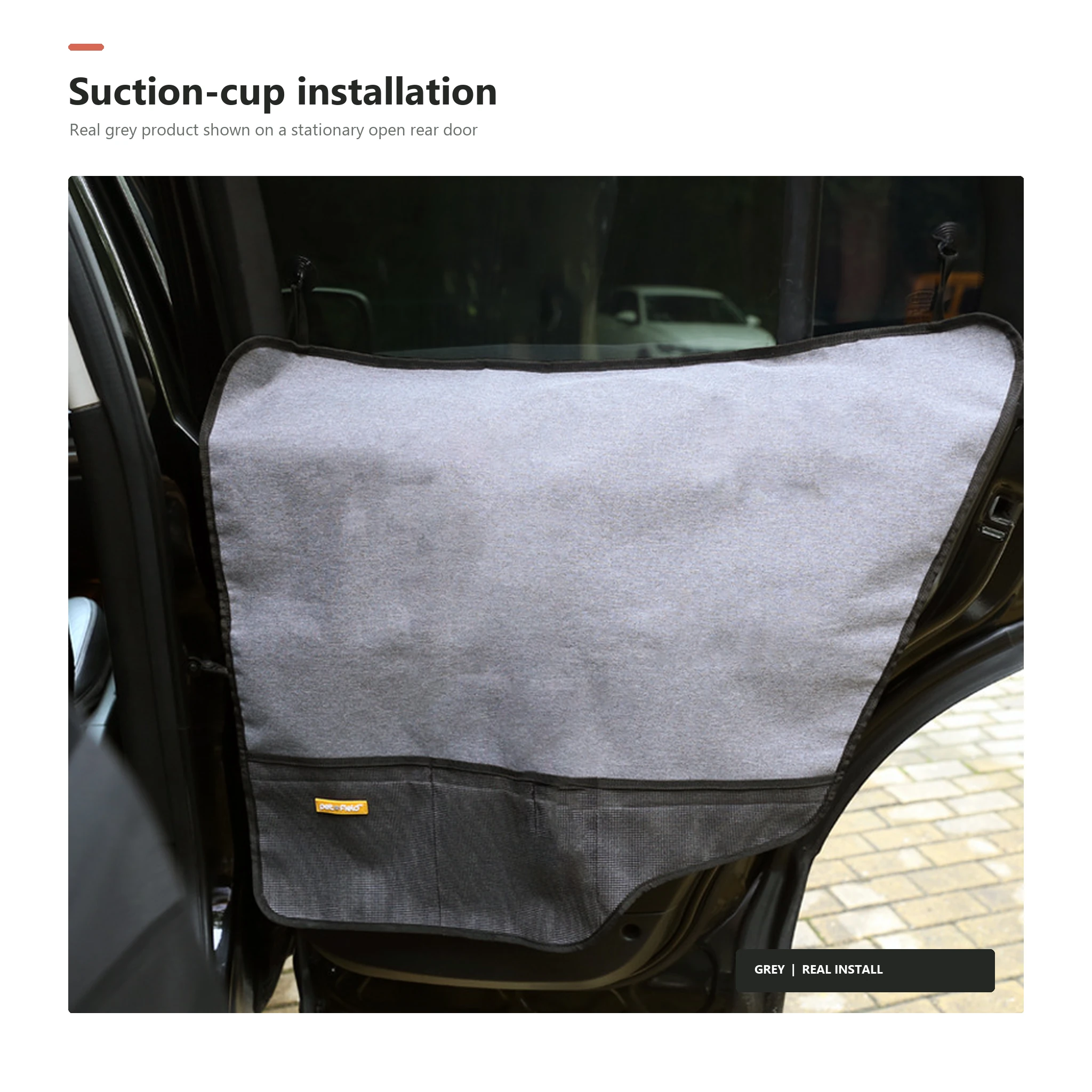 Grey dog car door protector installed on an open parked car rear door