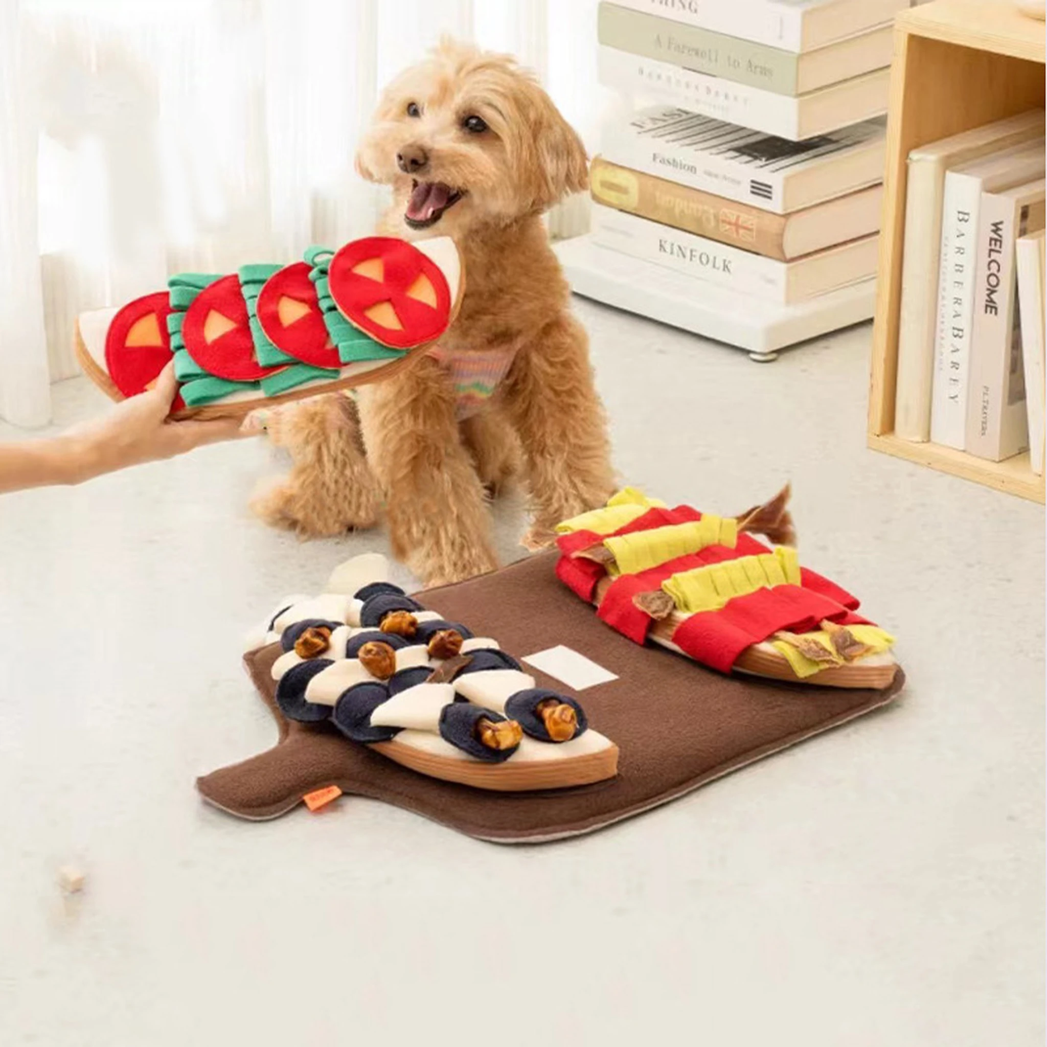 Hand holding the centre fabric section of the dog snuffle mat
