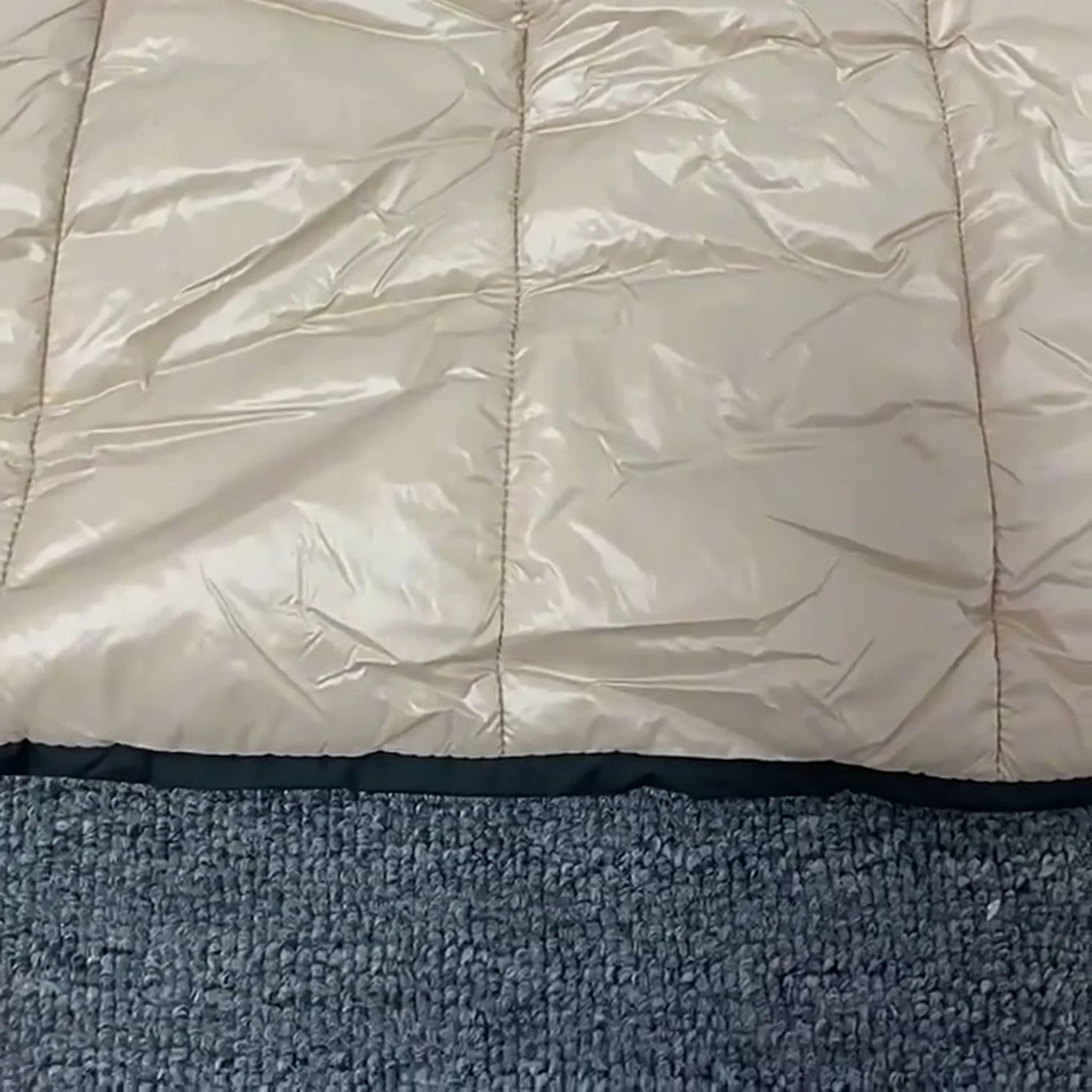 Close-up of beige stitched mat and dark edge binding