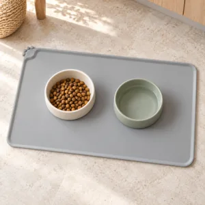 Grey silicone pet feeding mat with food and water bowls